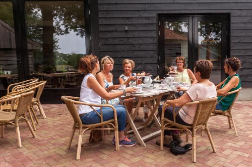 a group of people sitting around a table at Bed & breakfast Hoeve Springendal in Hezingen