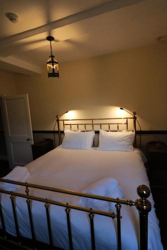 a bedroom with a large bed with white sheets and pillows at Appleby Castle in Appleby
