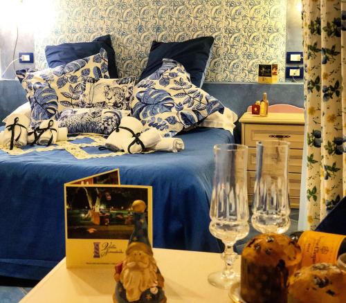 a bedroom with a bed with blue and white pillows at Villa Simitode in Cava deʼ Tirreni
