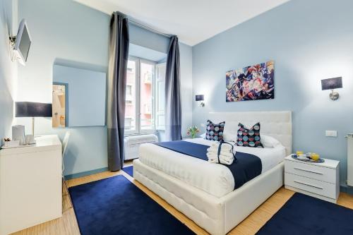 a blue bedroom with a bed and a window at Easy Budget Colosseo in Rome