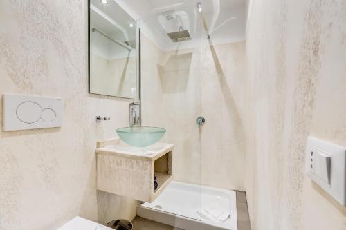 a bathroom with a sink and a glass bowl at Easy Budget Colosseo in Rome
