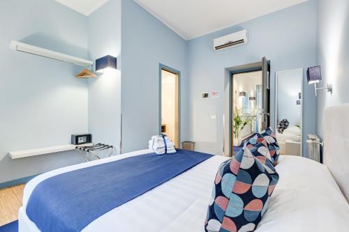 a blue and white bedroom with a large bed at Easy Budget Colosseo in Rome