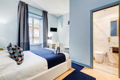 a bedroom with a large bed and a bathroom at Easy Budget Colosseo in Rome