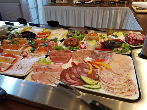 a buffet with many different types of food on a table at Hotel Herbst Berlin in Berlin