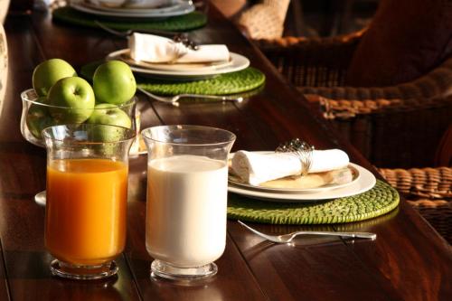 a table with plates of food and two glasses of milk at Branley Lodge Bed and Breakfast in Hillcrest