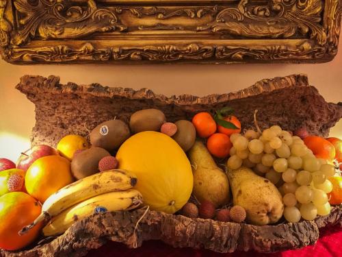 a display of fruits and vegetables in a gold frame at Hotel al Corso in Legnano