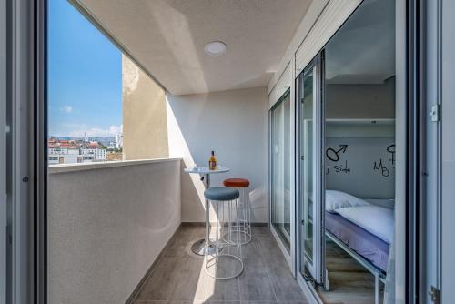 a small bedroom with a bed and a small table at Vista Spalato in Split