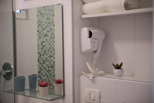 a bathroom with a glass shelf with a hair dryer at SMP Apartment 2 in Timişoara