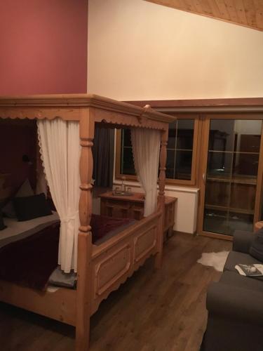 a bedroom with a canopy bed in a room at Hotel zum Urviech -Erwachsenenhotel- in Ehrwald