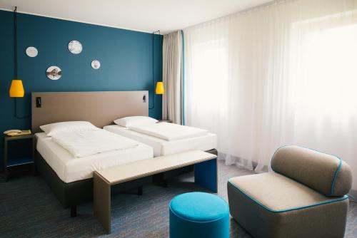 Кровать или кровати в номере Vienna House Easy by Wyndham Bad Oeynhausen