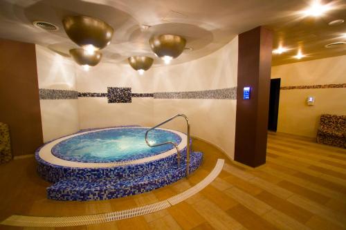 a bathroom with a large tub in a room at Hotel Gino Wellness Rabath in Akhaltsikhe