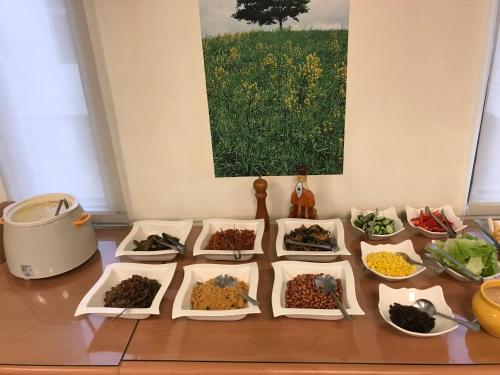 a table topped with lots of different types of food at Hiye Fashion Motel in Dounan