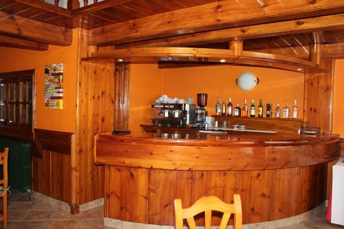 un bar dans un restaurant avec un mur en bois dans l'établissement Hotel La Bonaigua, à Vielha e Mijaran