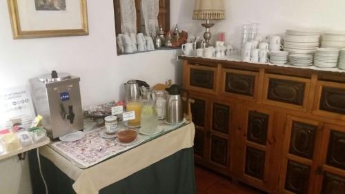 a table in a kitchen with a counter with food on it at Hotel Santa Isabel La Real in Granada