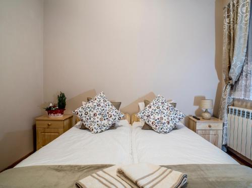 a bedroom with two beds with pillows on them at Osada Groń in Groń
