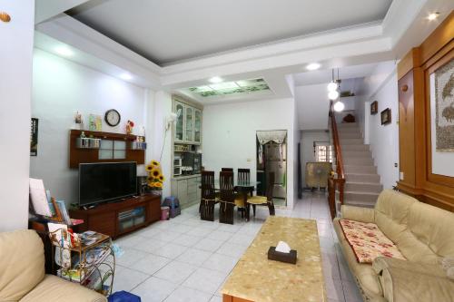 a living room with a couch and a tv at Dongshan River Left Bank in Wujie
