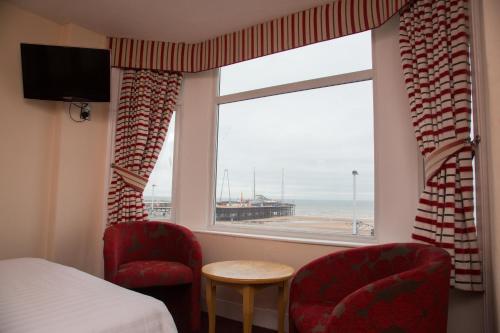 a bedroom with a window with a view of the beach at Viking Hotel - Adults Only in Blackpool