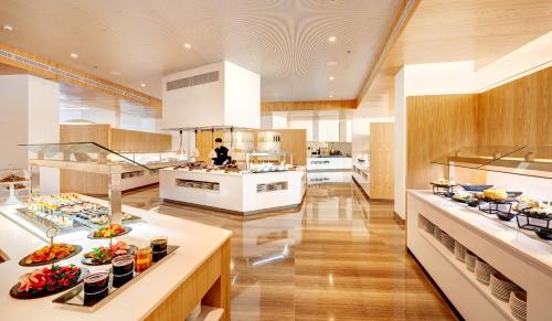 a large kitchen with many plates of food on display at Hipotels Playa de Palma Palace&Spa in Playa de Palma