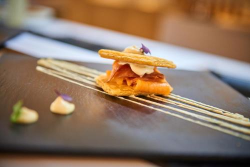 a piece of food sitting on a table with chopsticks at Hipotels Playa de Palma Palace&Spa in Playa de Palma