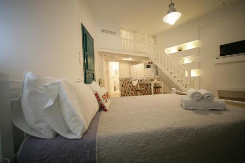 a bedroom with a bed with towels on it at Seaside Apartments in Adamantas