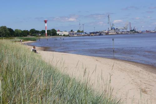 a sandy beach next to a body of water at Apartment Nordenham in Nordenham
