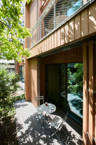 a patio with a table on the side of a building at Eden Lodge Paris in Paris
