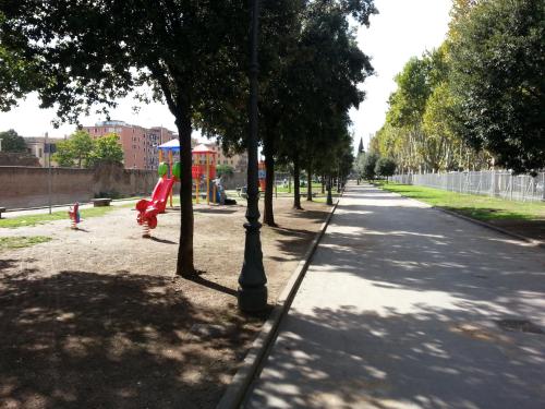 a tree lined street with a red fire hydrant at Domus Sessoriana in Rome