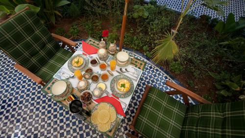 a table with plates of food on top at Ryad Salama in Fès