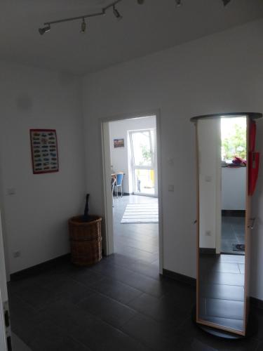 a living room with a door and a hallway at Fewo Max und Moritz in Bammental