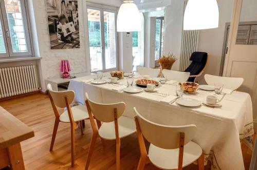 a dining room table with chairs and a white table cloth at Casale Bellaguardia in Fossombrone