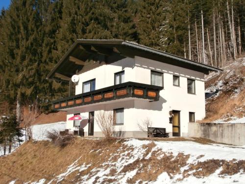 a house on top of a snow covered hill at Haus Nannerl in Sankt Jakob im Lesachthale