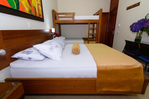 a bedroom with a bed and a bunk bed at Hotel Sauces del Estadio in Medellín