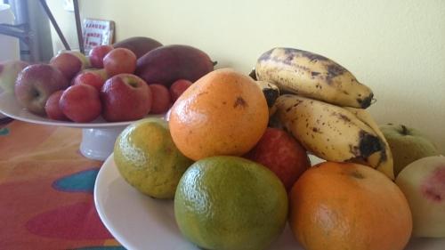 a pile of fruit on a plate on a table at Pousada Água Marinha in Caraguatatuba