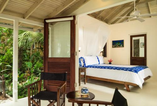 a bedroom with a bed and a table at GoldenEye in Oracabessa