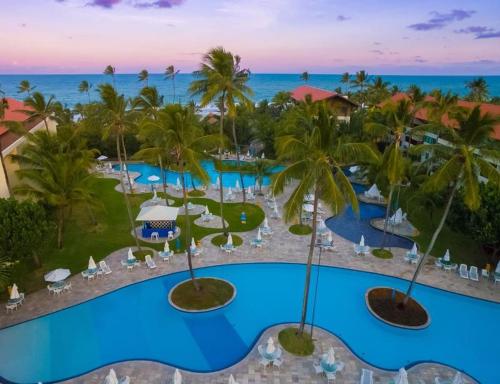 an aerial view of a resort with a pool at Flat Resort Marulhos in Porto De Galinhas