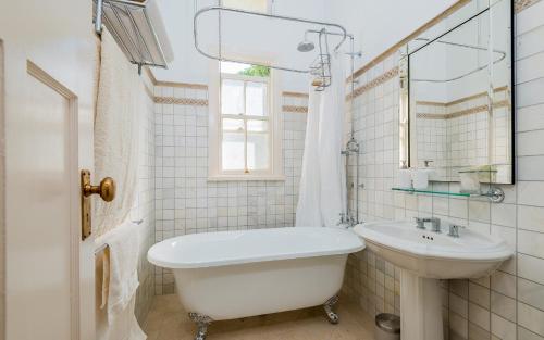 a bathroom with a sink and a tub and a toilet at Ithaca in Grafton