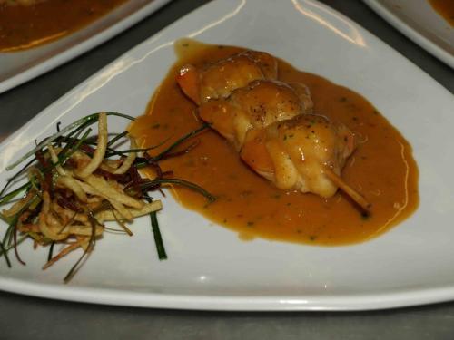 a plate of food with chicken in a sauce at Hotel Txartel in Lasarte
