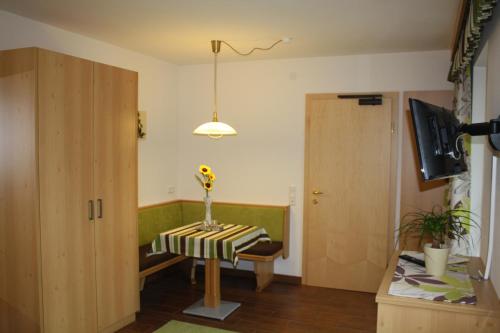 a room with a table with a vase of flowers on it at Zimmervermietung Babsy in Zell am See