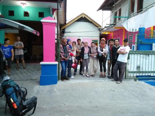 a group of people standing in front of a building at Homestay Lidiya in Banyuwangi