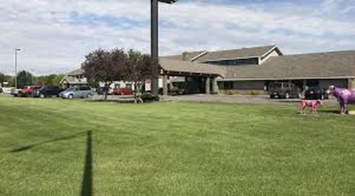 a building with a purple horse standing in a field at FairBridge Inn & Suites Thorp in Thorp