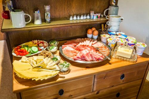 a table with many different types of food on it at Pension Forsthof in Maishofen