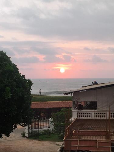 a sunset over the ocean from a house at Southern Comforts - Galle Fort in Galle