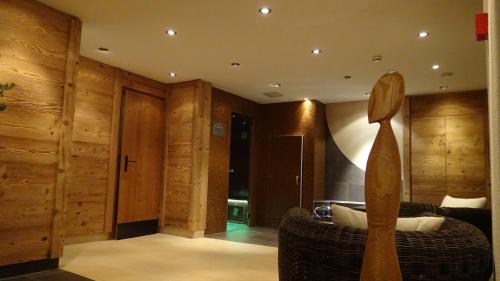 a living room with a couch and wooden walls at Hotel TURNA Malbun in Malbun
