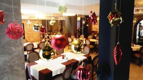 a dining room with a table with christmas ornaments at Family Hotel Delta in Ognyanovo