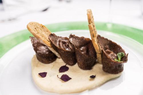 a white plate with some chocolate food on it at Hotel Winzerhof in Termeno