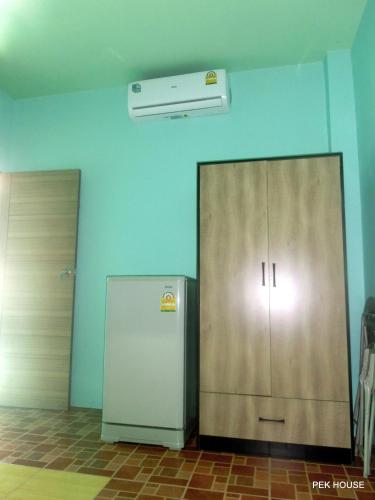 two metal cabinets and a refrigerator in a room at Pek House in Phuket Town