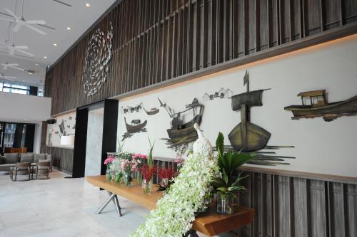 a lobby with a bunch of flowers on a wall at Oakwood Hotel & Residence Sri Racha in Si Racha