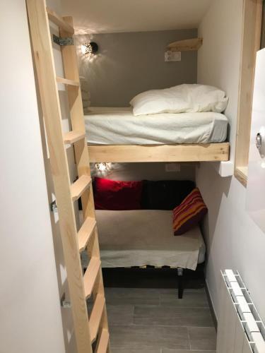 a small room with bunk beds and a bed at Boost Your Immo Vars Les Gentiannes 19 in Vars