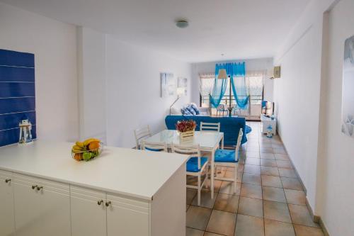 a kitchen and living room with a table and chairs at Krasas Beach Apts in Larnaka