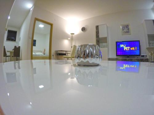 a silver chair sitting on a white table in a room at Apartmani Oletić 4* in Sveti Martin na Muri